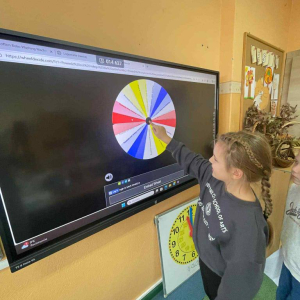 Uczniowie losują sobie zadania na kole życzliwości do wykonania na przerwie